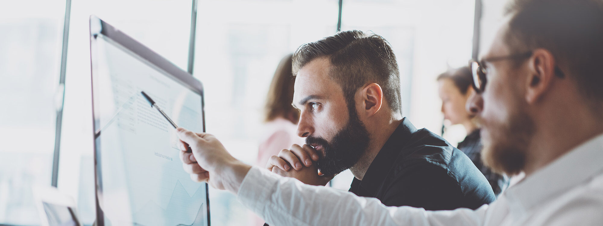 People looking at a monitor